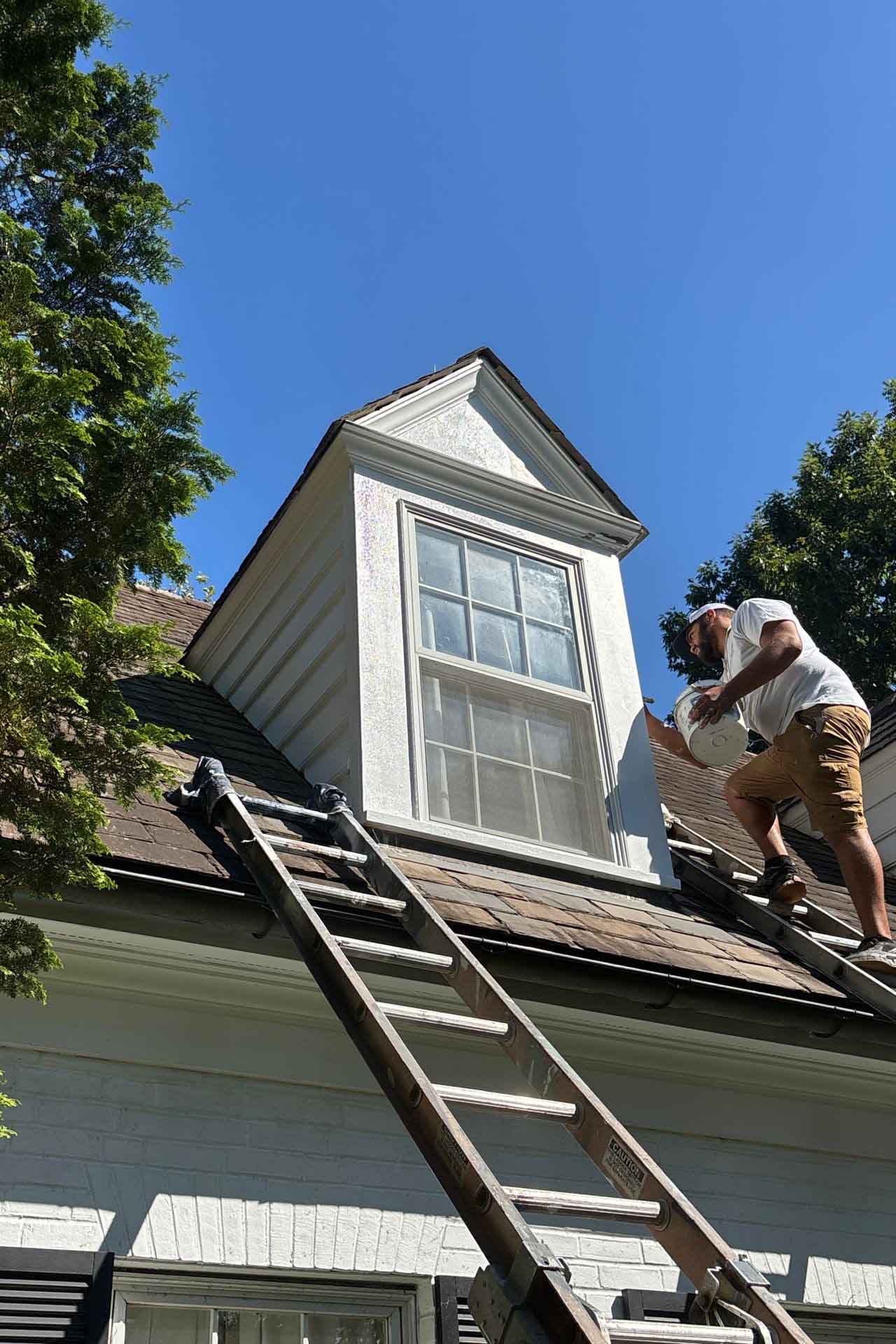 Residential home in Ohio with windows and brick columns masked with protective coverings during exterior painting preparation by Best Buy Painting.